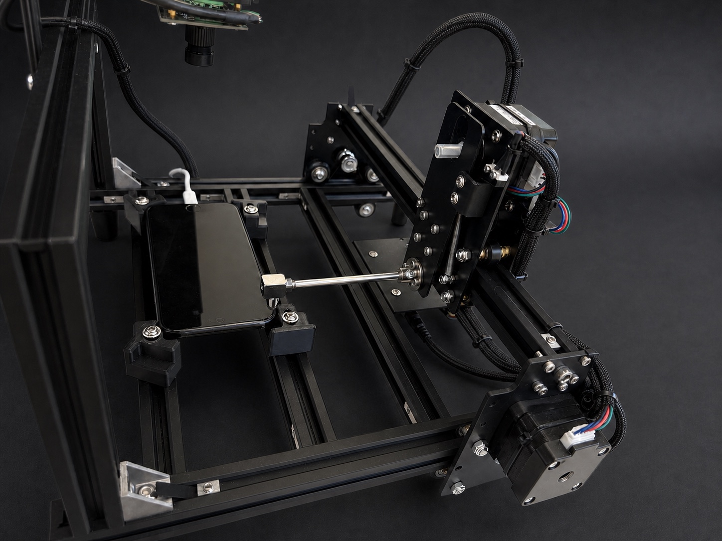 Close view of the Robot Hand carriage touching a real smartphone