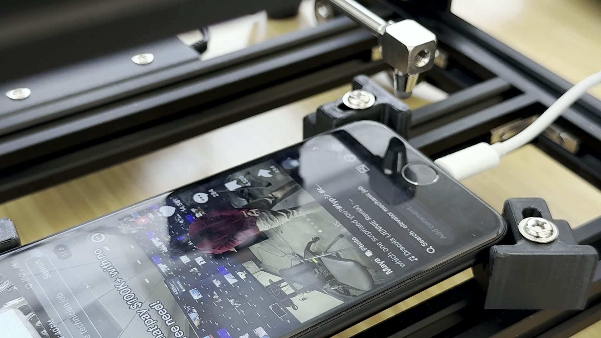 Real close-up of the PhoneFarm Robot Hand touching a phone